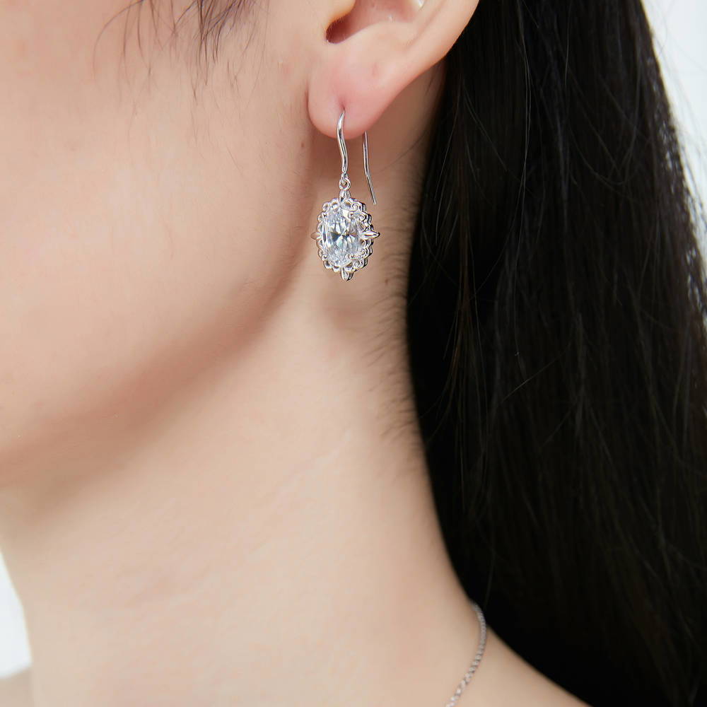 Model wearing Solitaire Filigree Oval CZ Fish Hook Earrings in Sterling Silver, 2 of 7