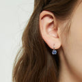 Model wearing Kaleidoscope Solitaire CZ Leverback Earrings in Sterling Silver, Purple Aqua Color