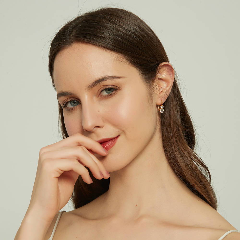Model wearing 2-Stone CZ Leverback Earrings in Sterling Silver, Yellow Gold Flashed