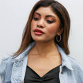 Model wearing Oval CZ Inside-Out Hoop Earrings in Sterling Silver 1.4 inch, Rhodium Plated