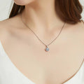 Model wearing Halo Kaleidoscope CZ Necklace in Sterling Silver, Greyish Blue