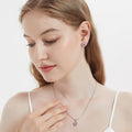 Model wearing Halo Kaleidoscope CZ Stud Earrings in Sterling Silver, Purple Color