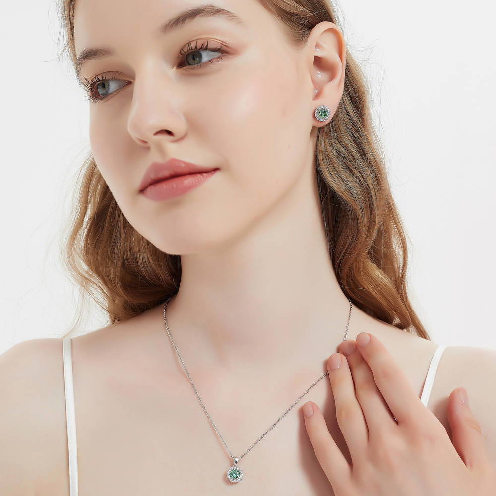 Model wearing Halo Kaleidoscope CZ Stud Earrings in Sterling Silver, Green Color