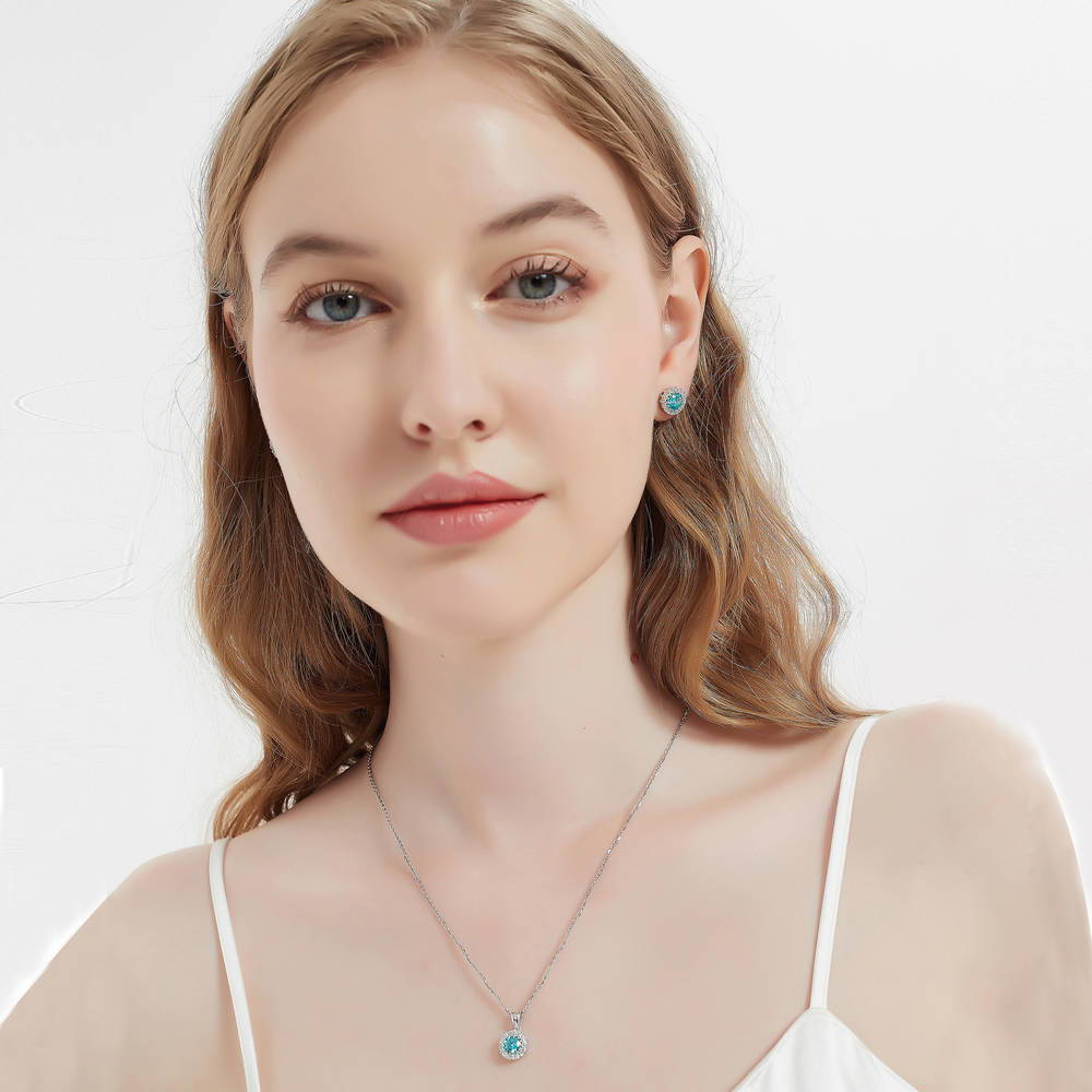 Model wearing Halo Kaleidoscope CZ Stud Earrings in Sterling Silver, Frosty Mint Color