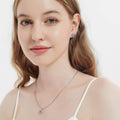 Model wearing Halo Kaleidoscope CZ Stud Earrings in Sterling Silver, Purple Aqua Color