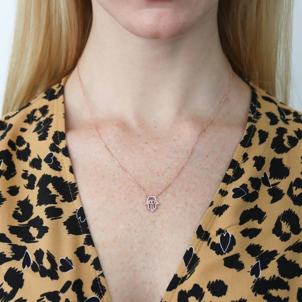 Model wearing Hamsa Hand Evil Eye CZ Necklace in Sterling Silver, Rose Gold Flashed