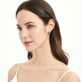 Model wearing Solitaire CZ Small Hoop Earrings in Sterling Silver 0.6 inch, Rhodium Plated
