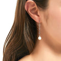 Model wearing Solitaire Oval Cultured Pearl Earrings in Sterling Silver, Yellow Gold Flashed