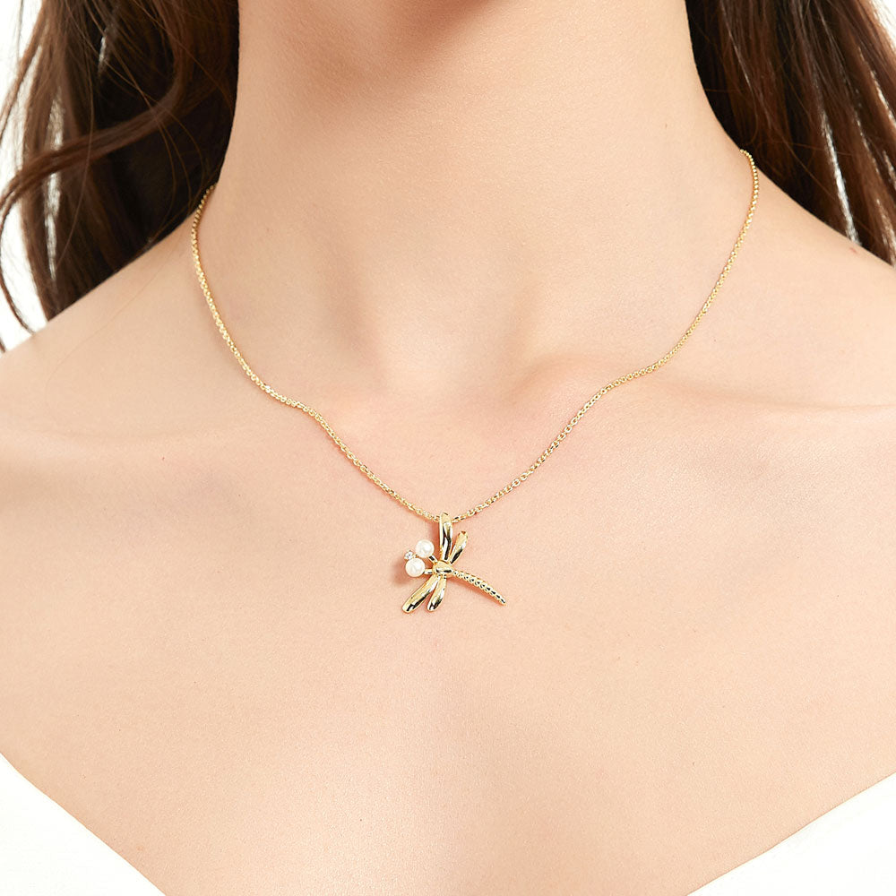 Model wearing Dragonfly Button Cultured Pearl Necklace in Sterling Silver, Yellow Gold Flashed