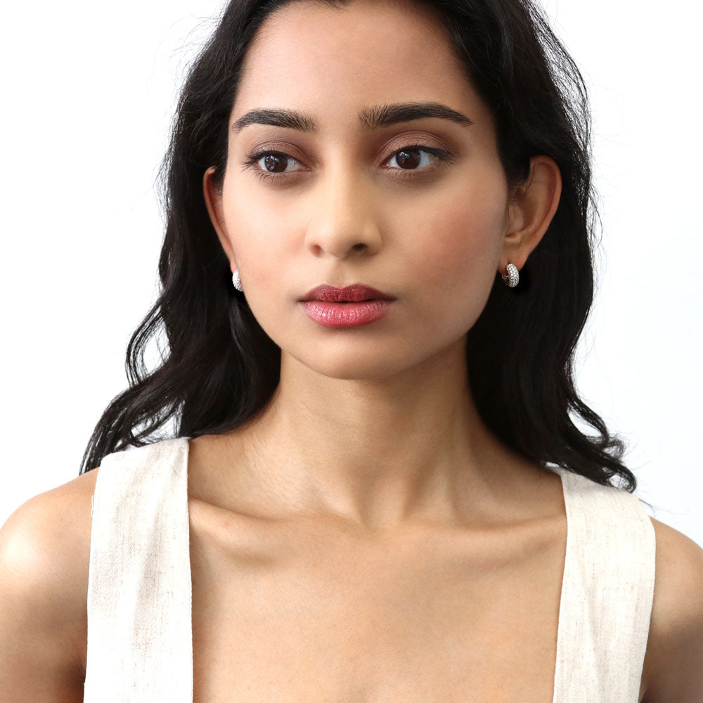 Model wearing Dome CZ Mini Cartilage Huggie Earrings in Sterling Silver 0.5 inch, Rhodium Plated