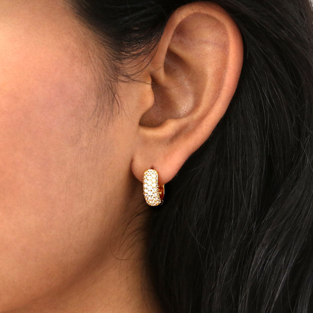 Model wearing Dome CZ Small Huggie Earrings in Sterling Silver 0.5 inch, Yellow Gold Flashed