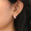 Model wearing Dome CZ Small Huggie Earrings in Sterling Silver 0.5 inch, Rose Gold Flashed