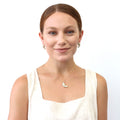 Model wearing Feather CZ Stud Earrings in Sterling Silver, Yellow Gold Flashed