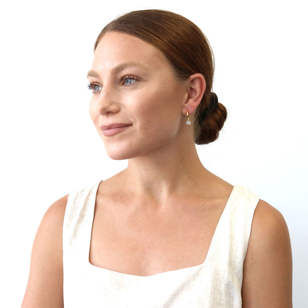 Model wearing Solitaire CZ Cartilage Huggie Earrings in Sterling Silver 0.5 inch, Yellow Gold Flashed / Round Cut
