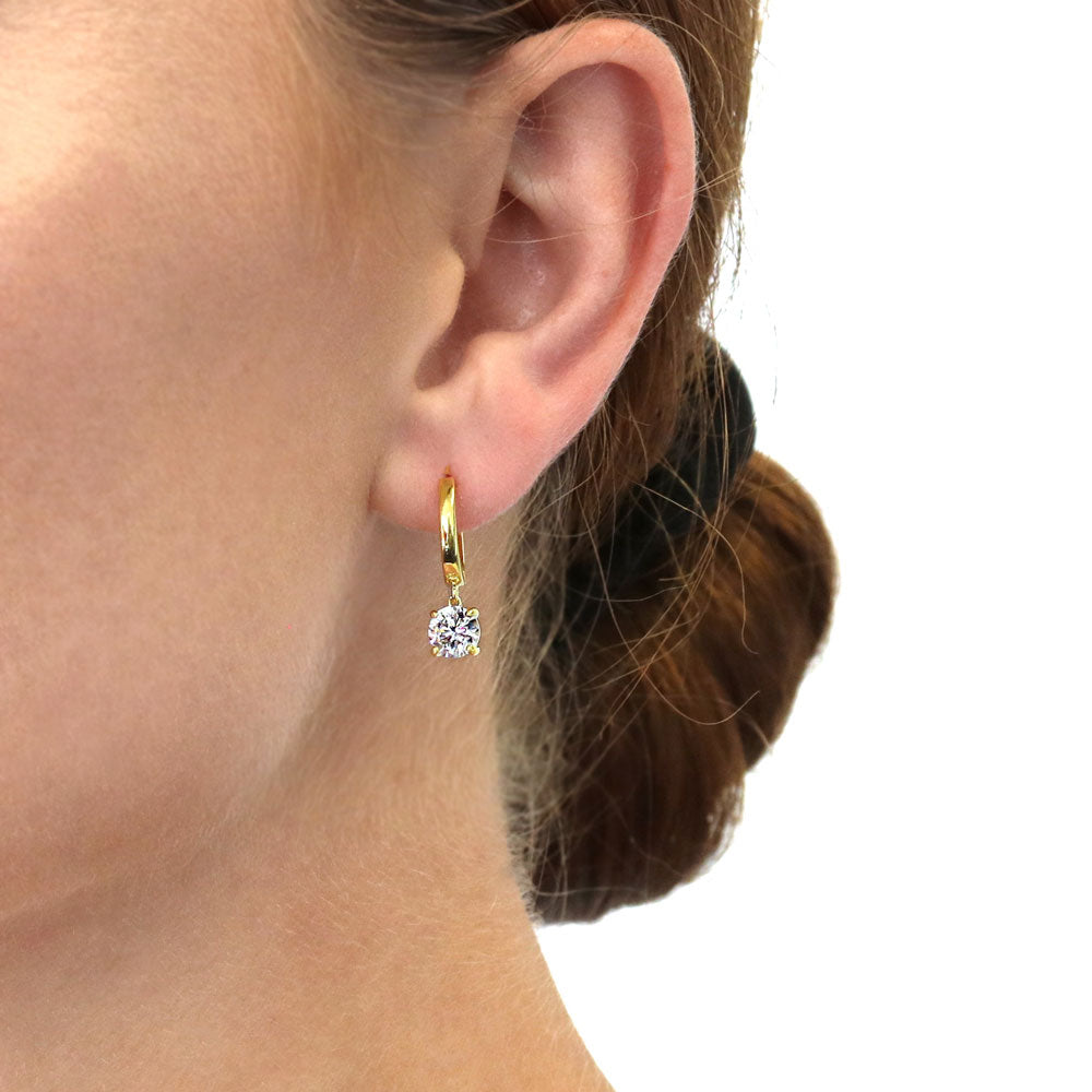 Model wearing Solitaire CZ Huggie Earrings in Sterling Silver 0.5 inch, 2 of 19