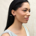 Model wearing Solitaire Black CZ Stud Earrings in Sterling Silver, 7mm