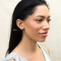 Model wearing Solitaire Black CZ Stud Earrings in Sterling Silver, 9mm