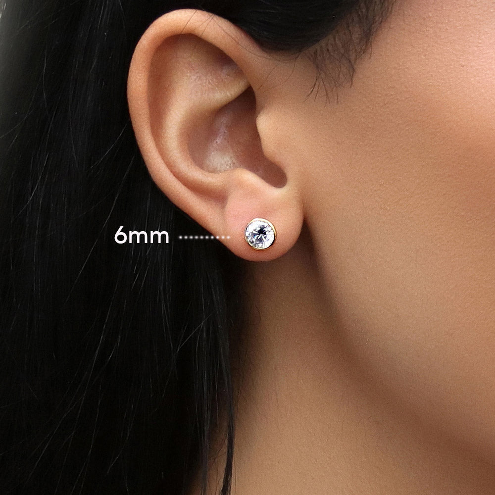 Model wearing Solitaire Bezel CZ Stud Earrings in Gold Flashed Sterling Silver, 4mm