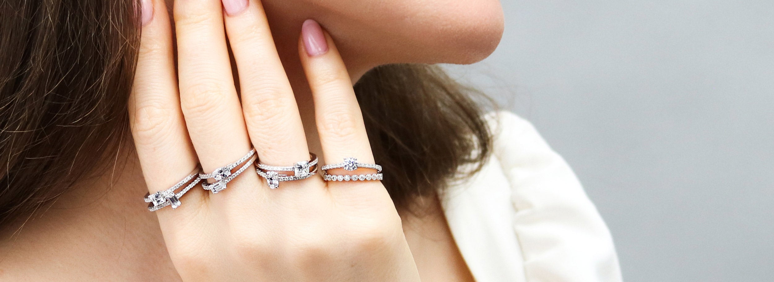 Model wearing stack of petite rings.