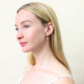 Model wearing Solitaire CZ Stud Earrings in Gold Flashed Sterling Silver, 4mm