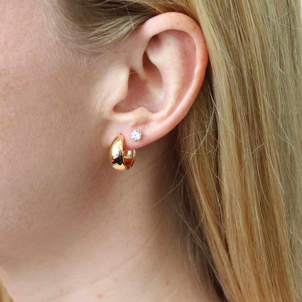 Model wearing Dome CZ Small Huggie Earrings in Sterling Silver 0.6 inch, Yellow Gold Flashed