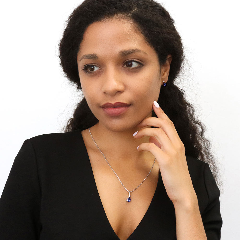 Model wearing Solitaire Pear Necklace in Sterling Silver 1ct, Tanzanite Color