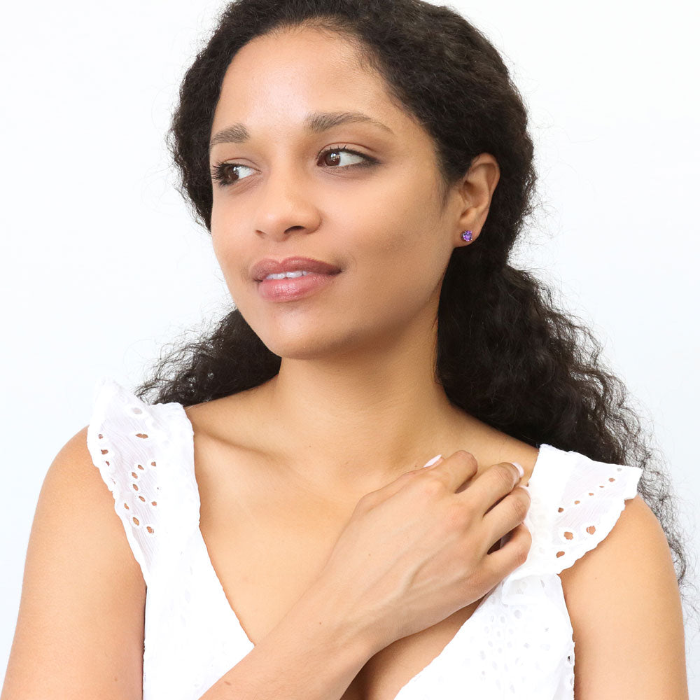 Model wearing Solitaire 1.6ct CZ Cartilage Stud Earrings in Sterling Silver, Amethyst Color