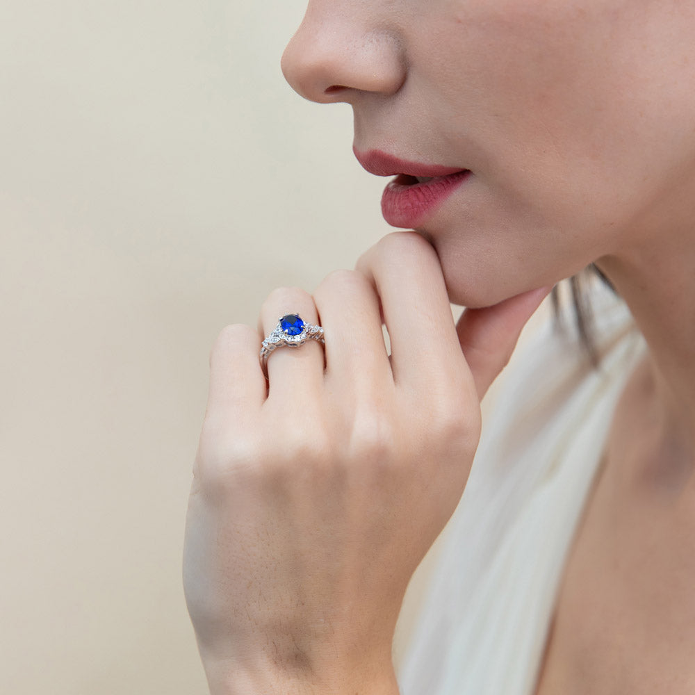 Model wearing Halo Simulated Blue Sapphire Oval CZ Ring Set in Sterling Silver, 13 of 16