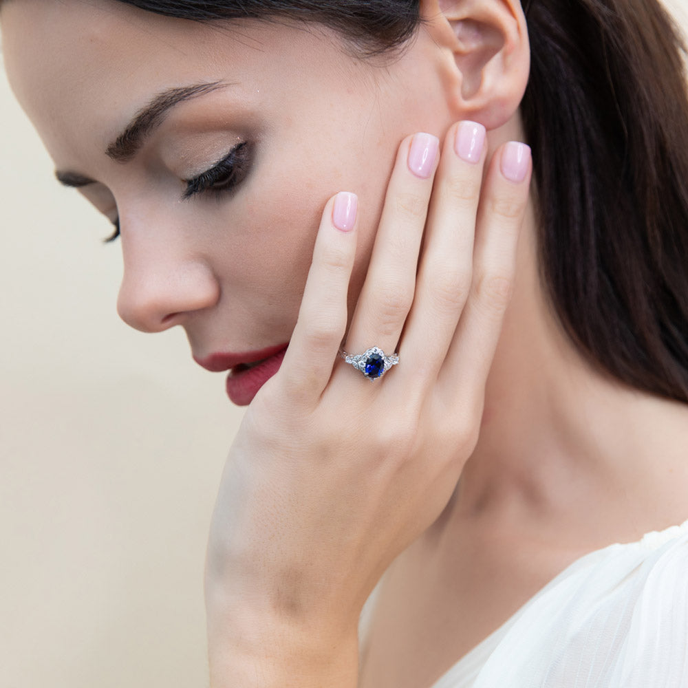 Model wearing Halo Simulated Blue Sapphire Oval CZ Ring Set in Sterling Silver, 9 of 16