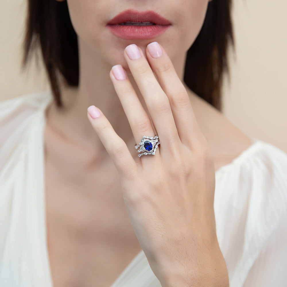Model wearing Halo Simulated Blue Sapphire Oval CZ Ring Set in Sterling Silver, 3 of 16