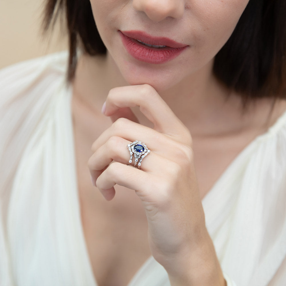 Model wearing Halo Simulated Blue Sapphire Oval CZ Ring Set in Sterling Silver, 7 of 16