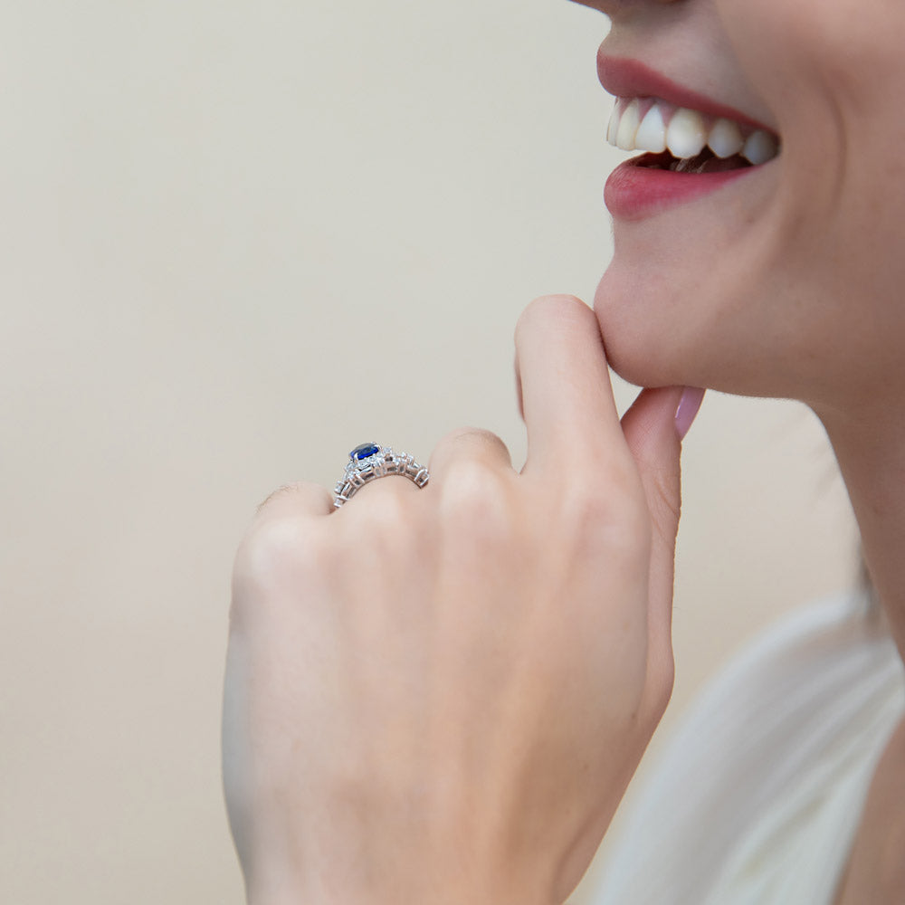 Model wearing Halo Simulated Blue Sapphire Oval CZ Ring Set in Sterling Silver, 6 of 16