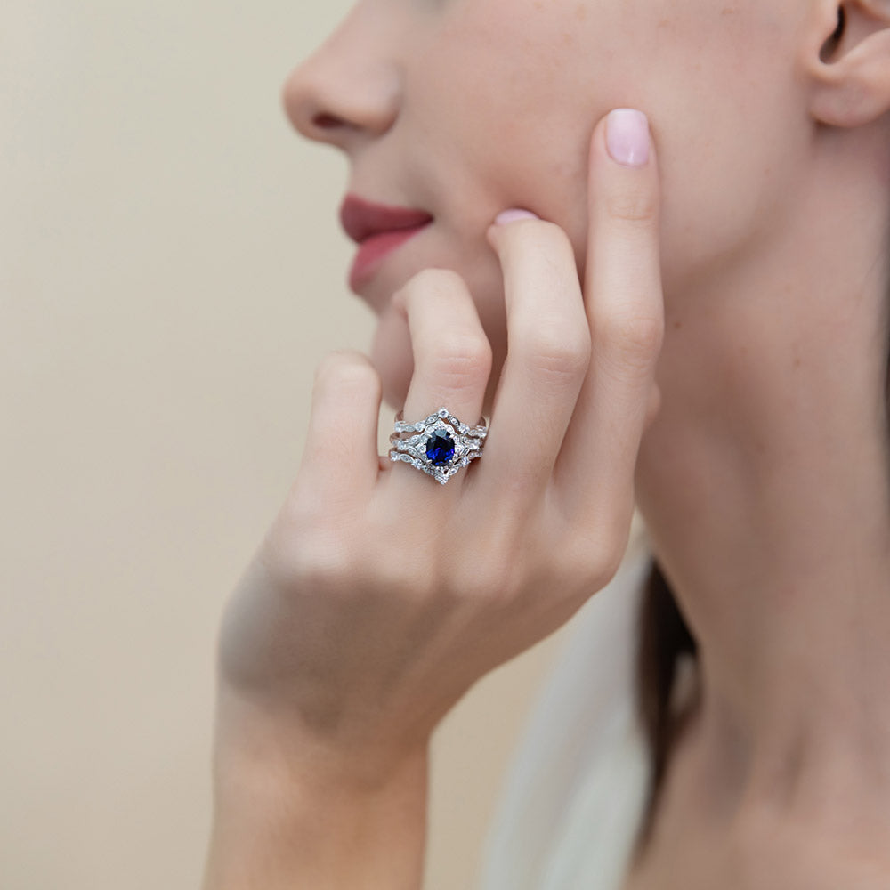 Model wearing Halo Simulated Blue Sapphire Oval CZ Ring Set in Sterling Silver, 2 of 16