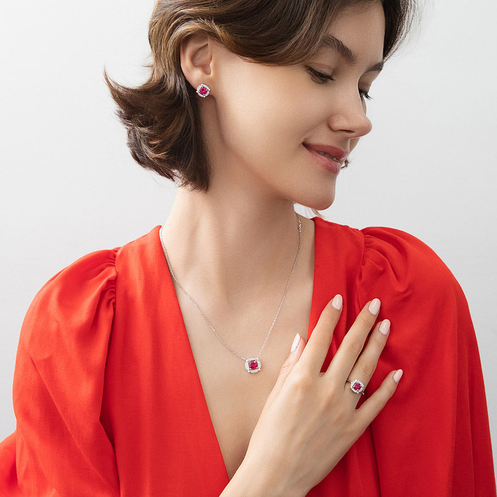 Model wearing Halo Flower Simulated Ruby CZ Ring in Sterling Silver, 10 of 11