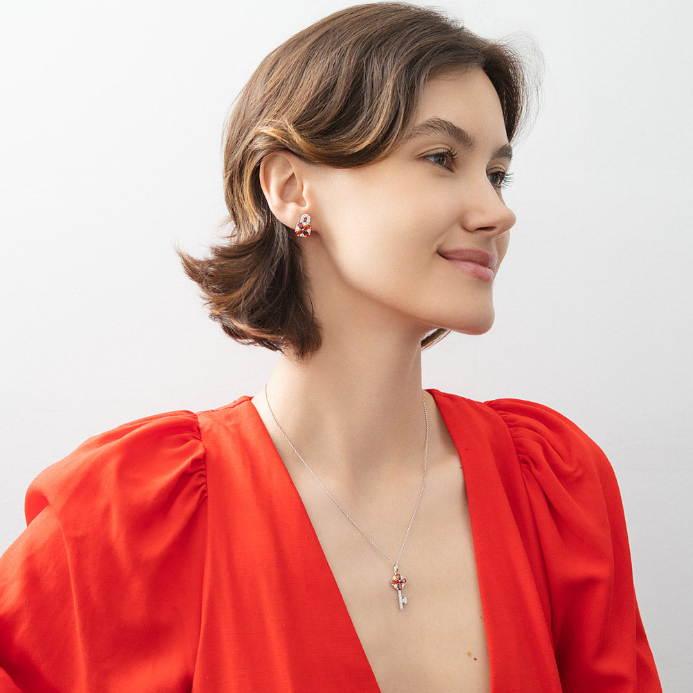 Model wearing Key and Lock CZ Stud Earrings in Sterling Silver, Red Color