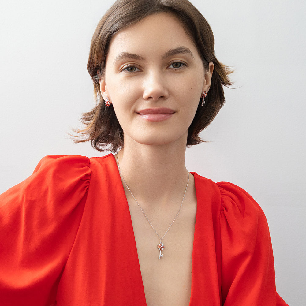 Model wearing Key and Lock CZ Stud Earrings in Sterling Silver, Red Color