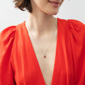 Model wearing Solitaire Pear Necklace in Sterling Silver 1ct, Tanzanite Color