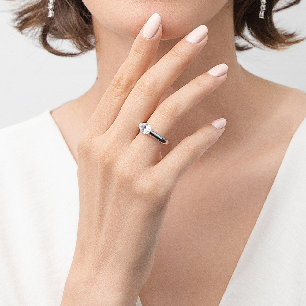 Model wearing Solitaire 1.2ct Half Bezel Set Oval CZ Ring in Sterling Silver, 2 of 8