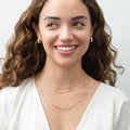 Model wearing Dome CZ Small Huggie Earrings in Sterling Silver 0.6 inch, Yellow Gold Flashed, Cubic Zirconia