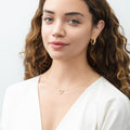 Model wearing Open Heart CZ Necklace in Sterling Silver, Yellow Gold Flashed