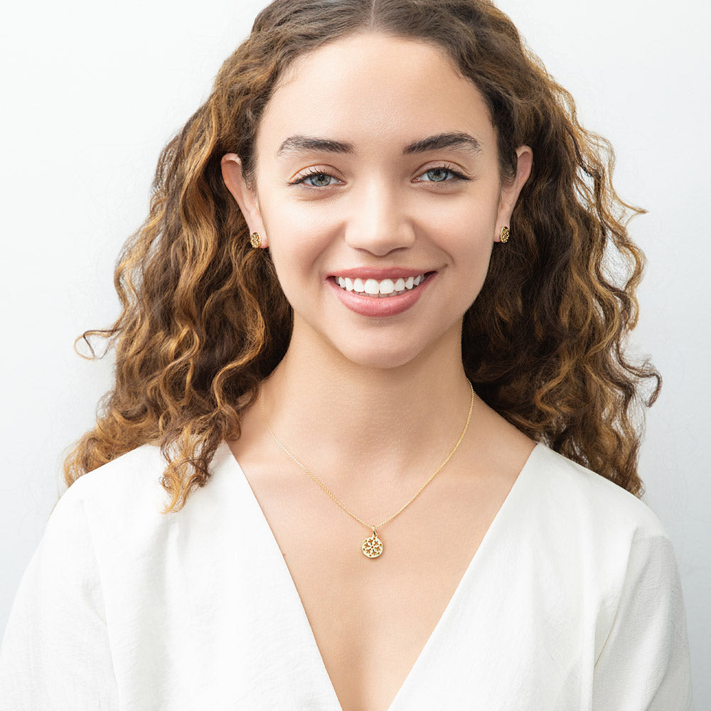 Model wearing Snowflake Coin Necklace and Earrings in Sterling Silver, Yellow Gold Flashed