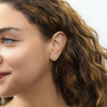 Model wearing Snowflake Coin Stud Earrings in Sterling Silver, Yellow Gold Flashed