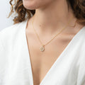 Model wearing Snowflake Coin Necklace and Earrings in Sterling Silver, Yellow Gold Flashed