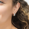 Model wearing Dome CZ Small Huggie Earrings in Sterling Silver 0.6 inch, Rhodium Plated, Cubic Zirconia