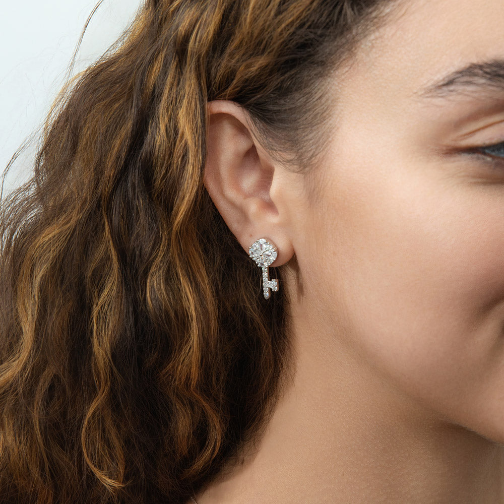 Model wearing Key and Lock CZ Stud Earrings in Sterling Silver, Clear Color