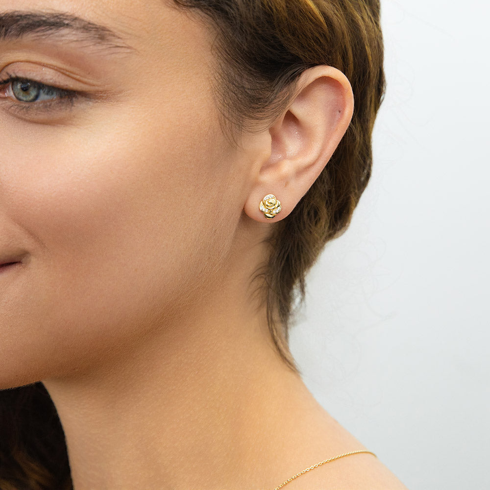 Model wearing Rose Flower CZ Cartilage Stud Earrings in Sterling Silver, Yellow Gold Flashed