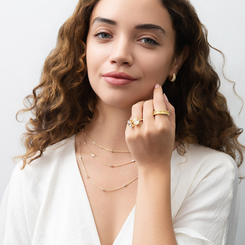 Model wearing Dome CZ Small Huggie Earrings in Sterling Silver 0.6 inch, Yellow Gold Flashed, Cubic Zirconia