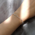 Model wearing Paperclip Link Chain Bracelet in Sterling Silver 4mm, Yellow Gold Flashed