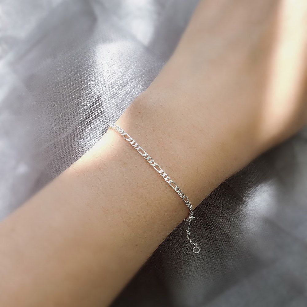 Model wearing Figaro Chain Bracelet in Sterling Silver, Yellow Gold Flashed
