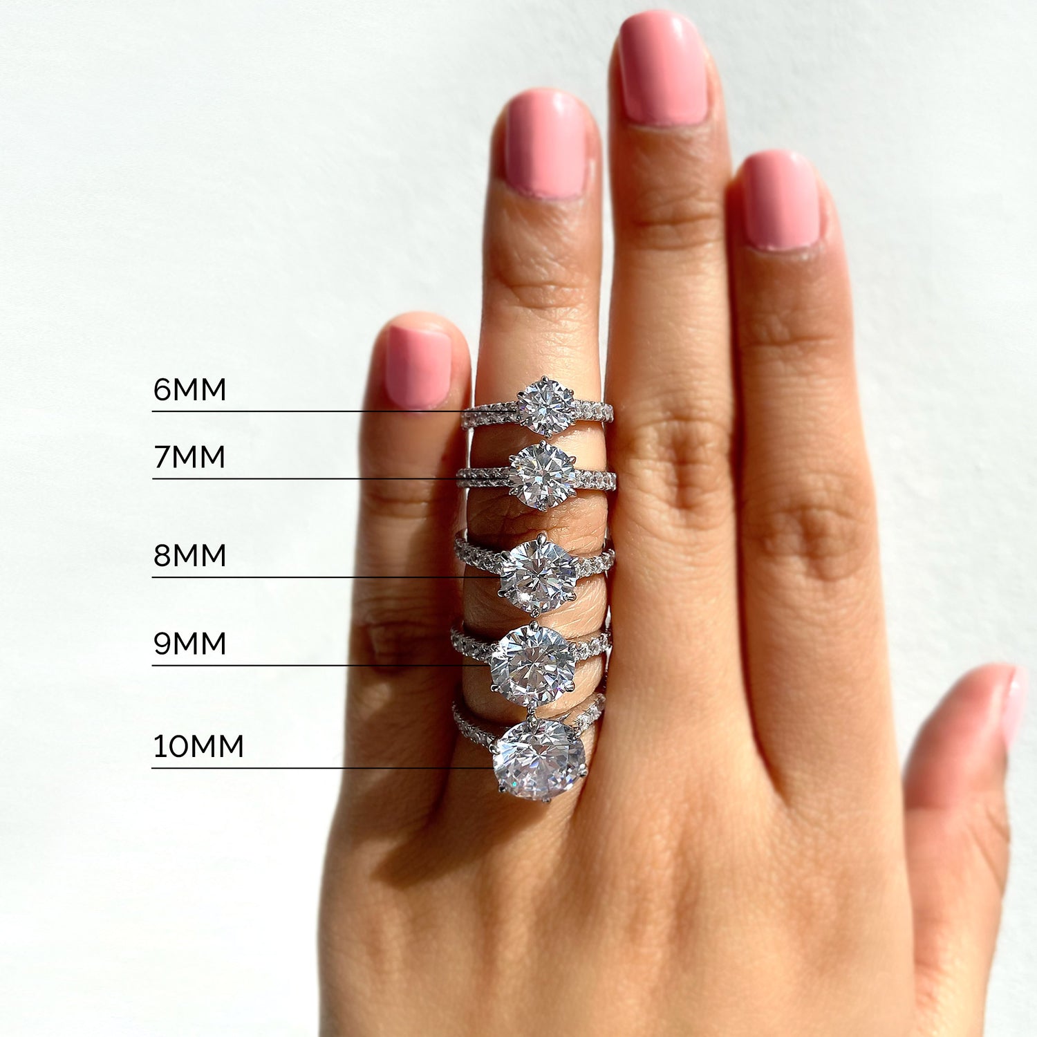 diamond carat sizes mm on a hand featuring various diamond carat weights